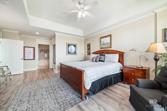 bedroom with crown molding, a raised ceiling, ceiling fan, and light wood-type flooring