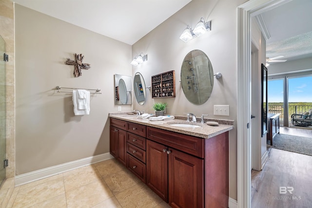 bathroom featuring walk in shower, vanity, and tile patterned flooring