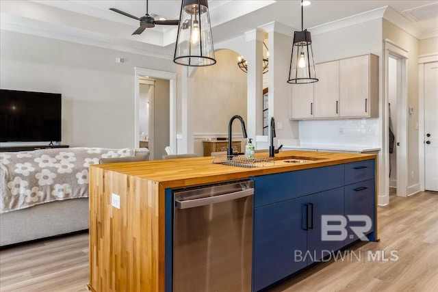kitchen with crown molding, dishwasher, wood counters, a sink, and open floor plan