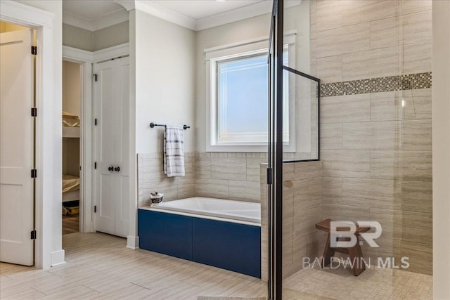 bathroom with a tile shower, crown molding, and a garden tub
