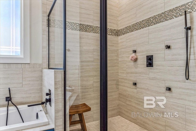 full bath with a bath and a shower stall