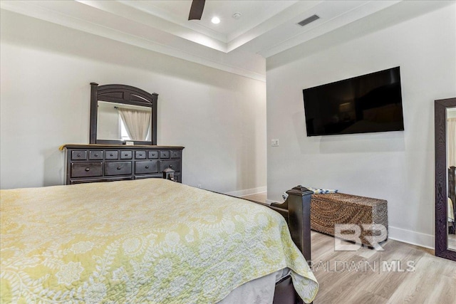 bedroom featuring visible vents, crown molding, baseboards, wood finished floors, and recessed lighting