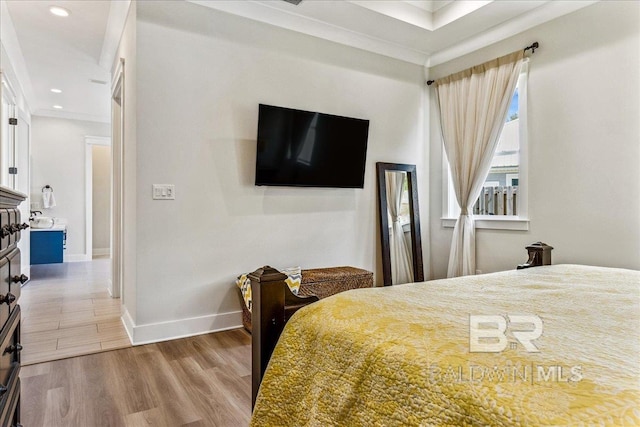 bedroom with baseboards, ornamental molding, wood finished floors, and recessed lighting