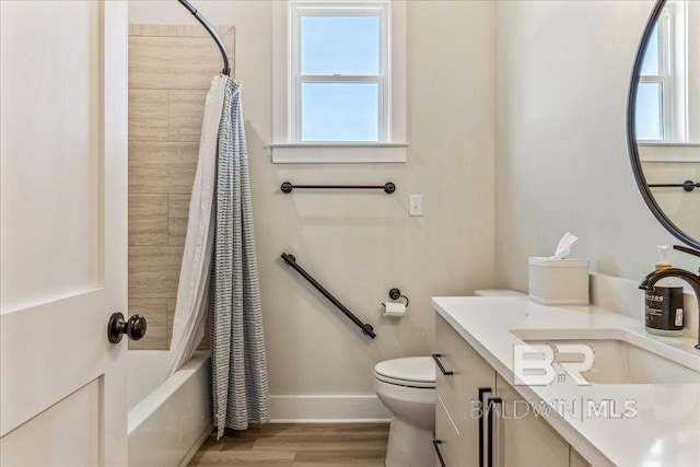 full bathroom featuring vanity, shower / tub combo with curtain, toilet, baseboards, and wood finished floors