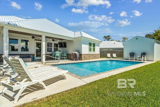 pool featuring ceiling fan, a yard, fence, and a patio area