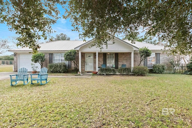 single story home featuring a porch, a garage, and a front yard