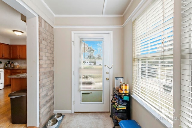 doorway with light carpet and ornamental molding