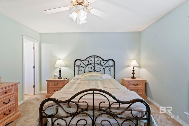 bedroom with ceiling fan and light carpet