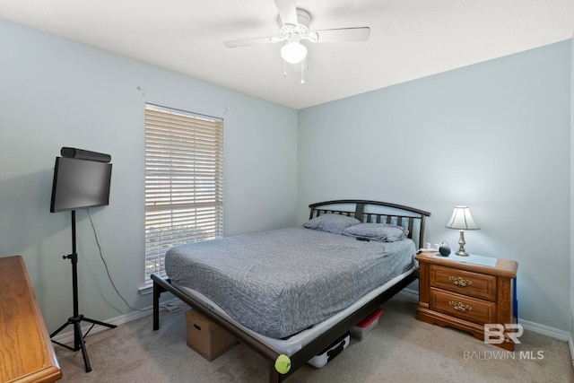 bedroom featuring ceiling fan and light carpet