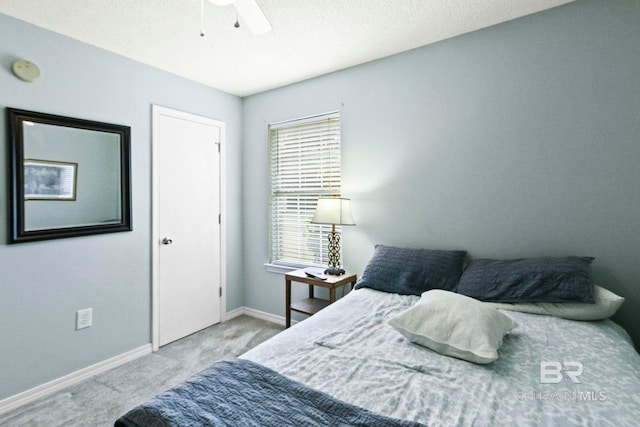 bedroom featuring ceiling fan and light carpet