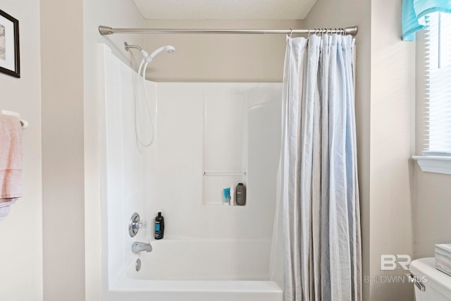 bathroom featuring a textured ceiling, toilet, and shower / bathtub combination with curtain