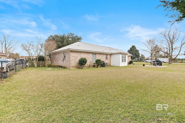 view of home's exterior featuring a lawn and central air condition unit