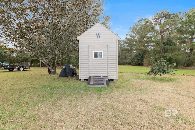 view of outbuilding with a yard