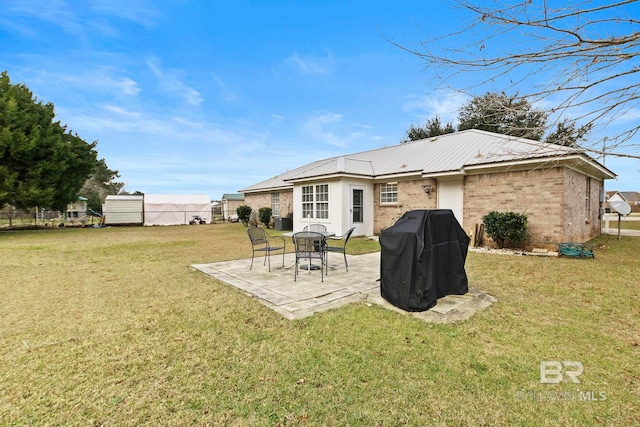 rear view of house with a patio area and a yard