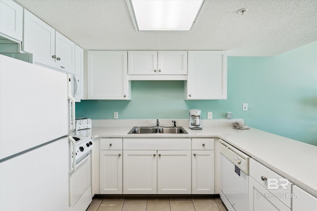 kitchen featuring a textured ceiling, white appliances, white cabinetry, and sink