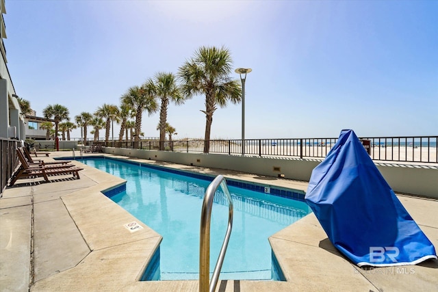 view of swimming pool with a patio