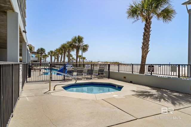 view of swimming pool with a patio area