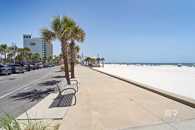 view of road with a water view and a beach view