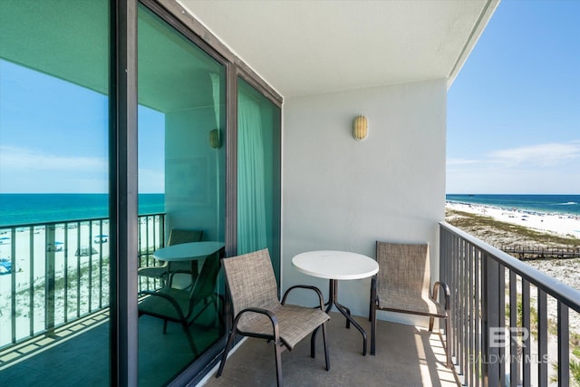 balcony with a beach view and a water view