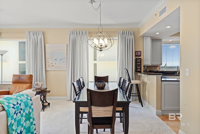 13621 Perdido Key Dr Unit 1804W, Perdido Key, FL 32507 - dining area with a notable chandelier, ornamental molding, and light carpet