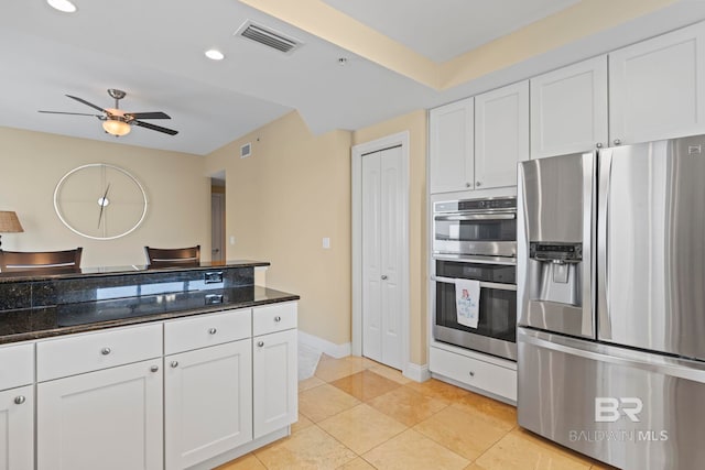 13621 Perdido Key Dr Unit 1804W, Perdido Key, FL 32507 - kitchen featuring dark stone countertops, appliances with stainless steel finishes, light tile patterned flooring, ceiling fan, and white cabinets