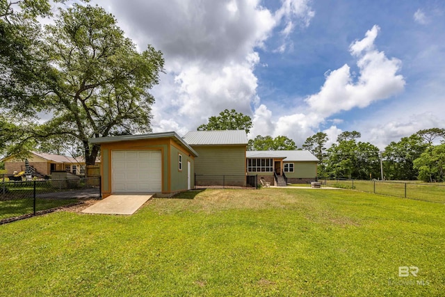 exterior space with a front yard, metal roof, and a fenced backyard