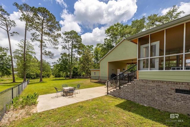 view of yard with a patio area, stairway, and a fenced backyard