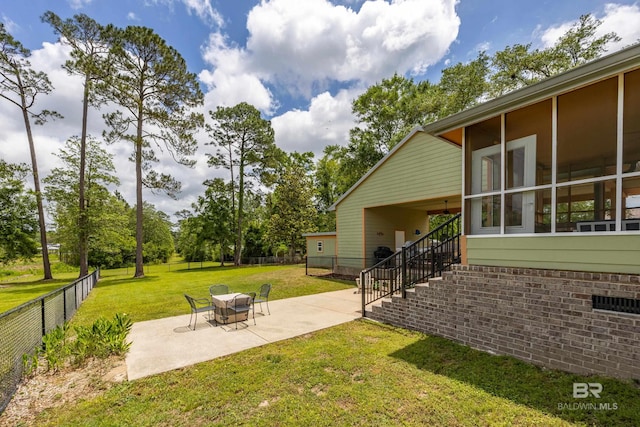 view of yard with a patio, a fenced backyard, and stairs