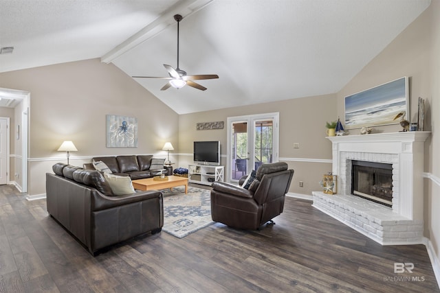 living area featuring dark wood-type flooring, visible vents, ceiling fan, a brick fireplace, and vaulted ceiling with beams