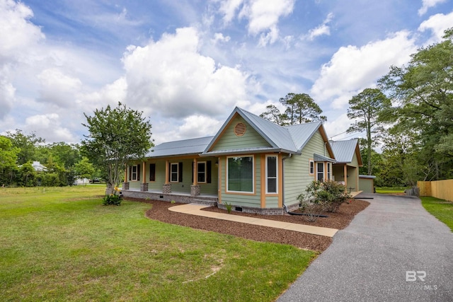 view of front facade with a porch, driveway, crawl space, metal roof, and a front lawn