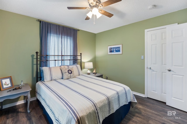 bedroom with a textured ceiling, baseboards, a ceiling fan, and wood finished floors