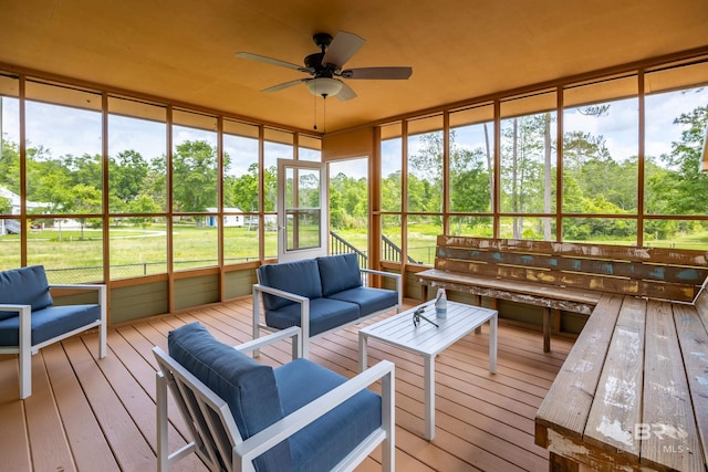 sunroom with outdoor lounge area and ceiling fan