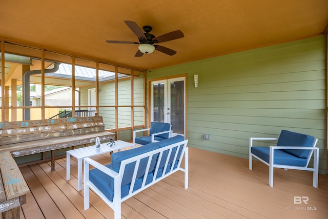 wooden deck with ceiling fan and french doors