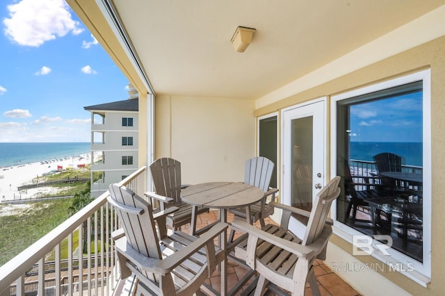 balcony featuring a water view and a view of the beach