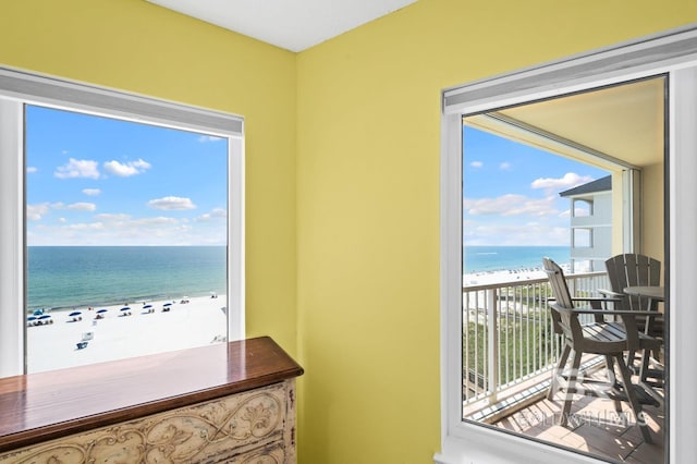 interior space with a water view and a beach view