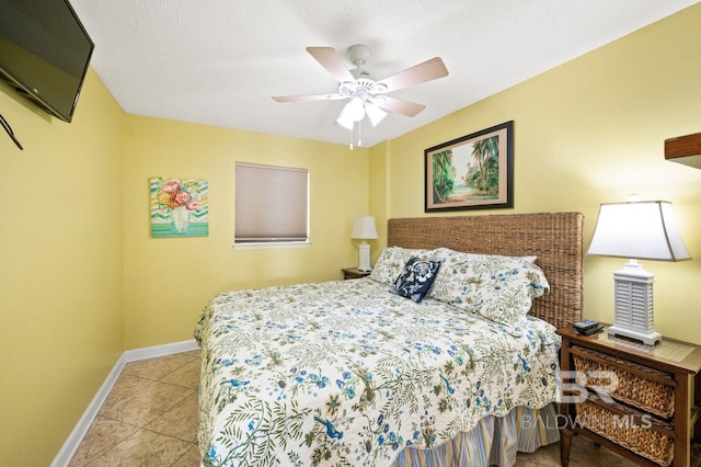 bedroom with ceiling fan and light tile patterned floors