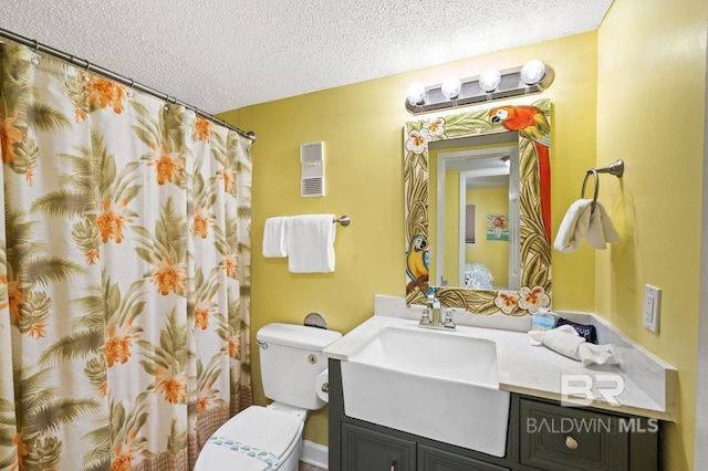 bathroom with vanity, a shower with curtain, a textured ceiling, and toilet