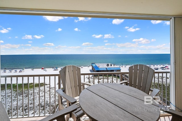 balcony featuring a water view and a beach view