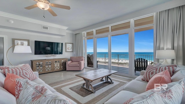 living room with a water view, ornamental molding, ceiling fan, and light tile flooring