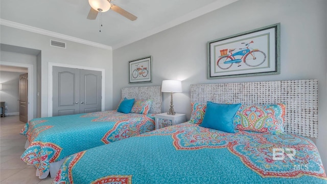 bedroom featuring tile floors, ceiling fan, a closet, and ornamental molding