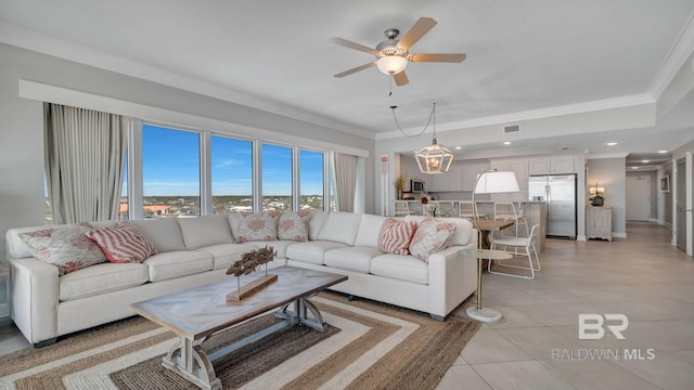 living room with ceiling fan, ornamental molding, and light tile floors