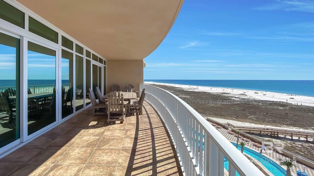 balcony with a view of the beach and a water view