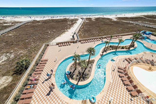 drone / aerial view with a water view and a view of the beach