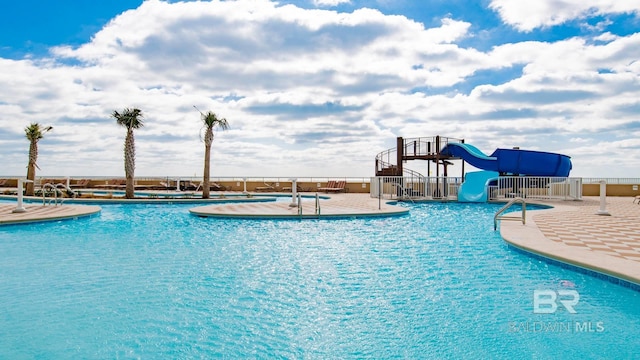 view of pool with a water slide