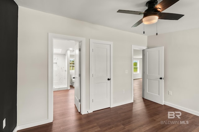 unfurnished bedroom with dark wood-style floors, ceiling fan, and baseboards