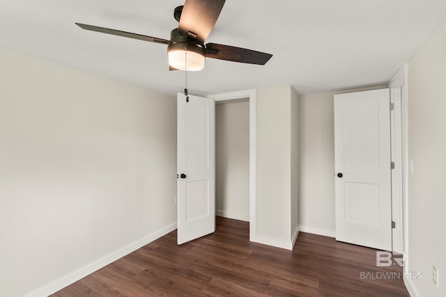 unfurnished bedroom featuring baseboards, ceiling fan, and dark wood finished floors