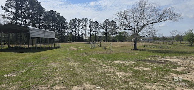 view of yard featuring a detached carport and fence
