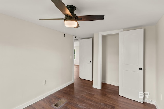 unfurnished bedroom with dark wood finished floors, baseboards, visible vents, and ceiling fan