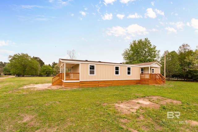 back of property with a lawn