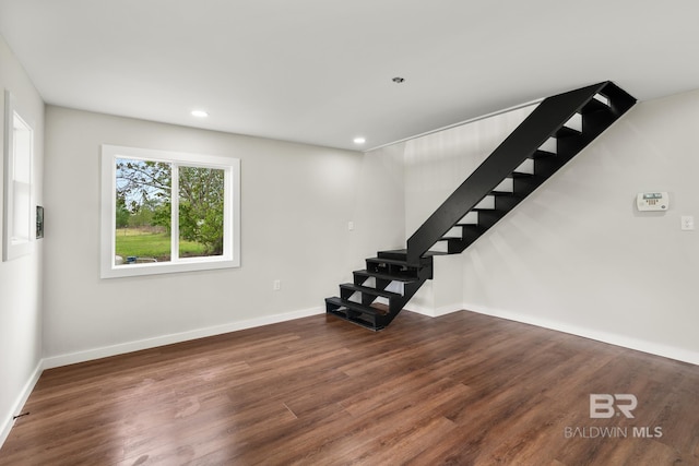 interior space featuring stairs, wood finished floors, baseboards, and recessed lighting